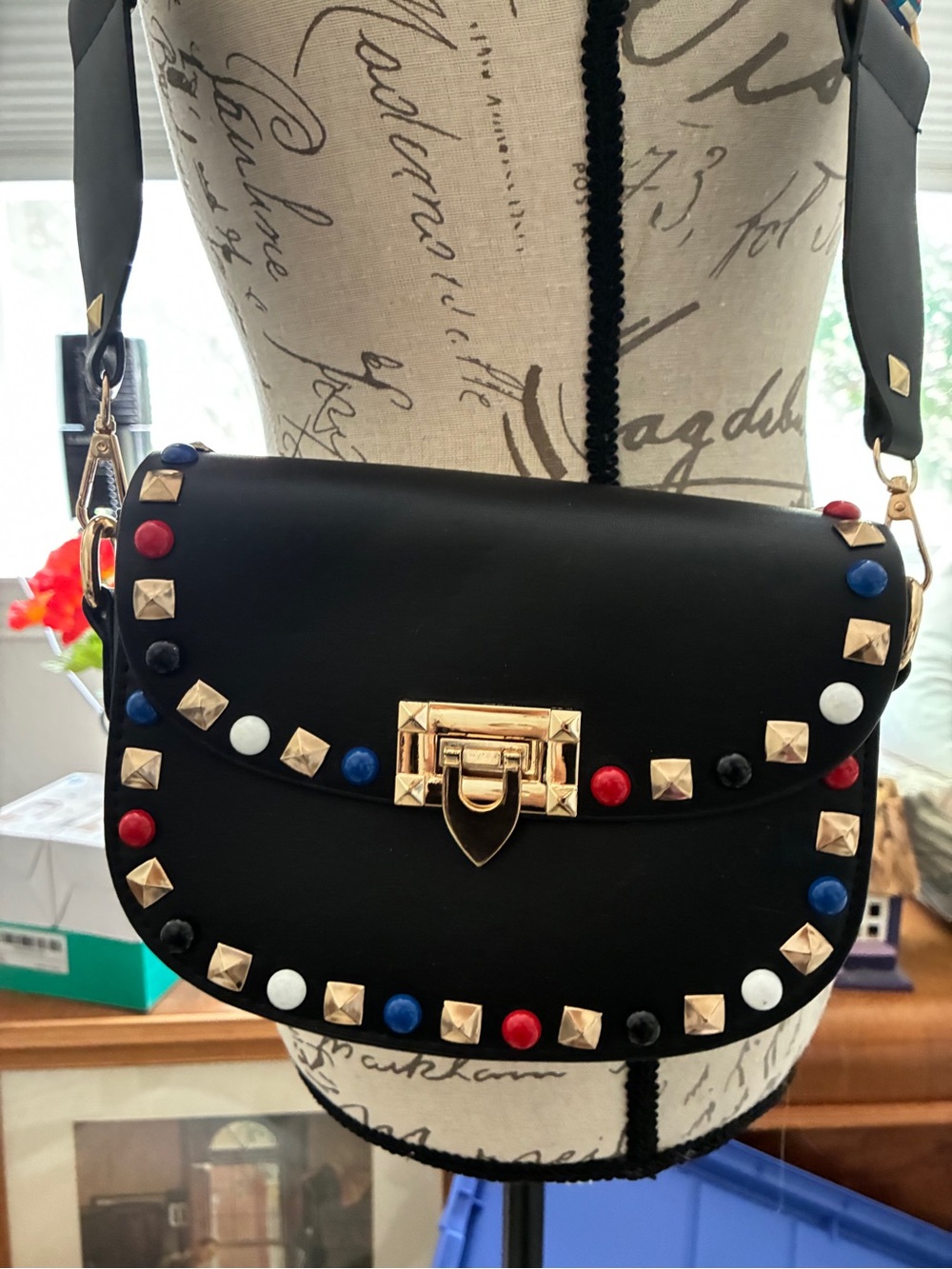 Black Studded Crossbody Bag with Multicolor Accents Gold Hardware guitar strap.